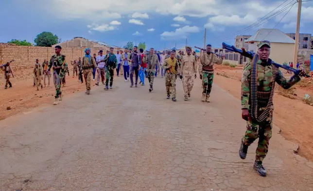 Government troops patrol alongside government officials after clashes with militias that killed dozens of people, including civilians, in Baidoa, Somalia, Monday, Aug. 17, 2026. (AP Photo)