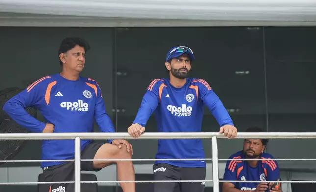 India's Ravindra Jadeja, right, and a team official wait in the team dressing room as play is delayed due to rain during the second day of the first Test cricket match between Sri Lanka and India in Galle, Sri Lanka, Sunday, Aug. 16, 2026. (AP Photo/Eranga Jayawardena)