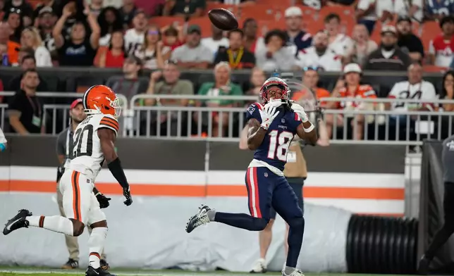New England Patriots wide receiver Kyle Williams (18) catches a pass for a touchdown as Cleveland Browns defensive back D'Angelo Ross (20) defends during the first half of a preseason NFL football game Thursday, Aug. 27, 2026, in Cleveland. (AP Photo/Carolyn Kaster)