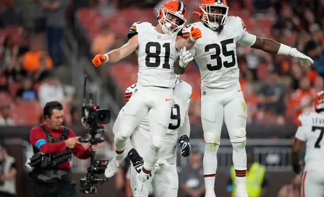Cleveland Browns wide receiver Luke Floriea (81) celebrates with Raheim Sanders (35) after scoring a touchdown during the first half of a preseason NFL football game against the New England Patriots Thursday, Aug. 27, 2026, in Cleveland. (AP Photo/Carolyn Kaster)