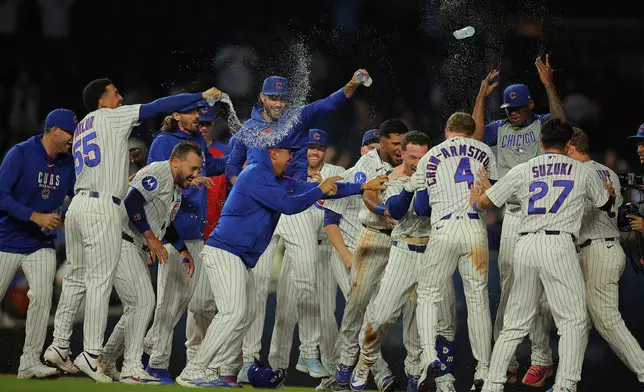 Chicago Cubs' Alex Bregman celebrates with his teammates after his game winning hit during the ninth inning of a baseball game against the Chicago White Sox, Tuesday, Aug. 18, 2026, in Chicago. (AP Photo/Melissa Tamez)