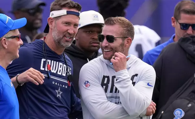 Dallas Cowboys head coach Brian Schottenheimer, center, talks with Los Angeles Rams head coach Sean McVay during an NFL football joint practice, Tuesday, Aug. 11, 2026, in Los Angeles. (AP Photo/Mark J. Terrill)
