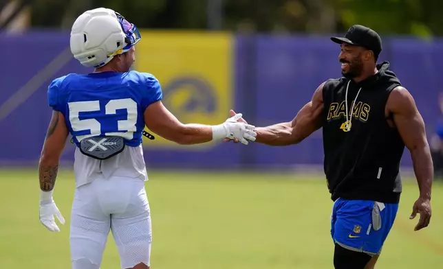 Los Angeles Rams linebacker Nate Landman, left, shakes hands with defensive end Myles Garrett during an NFL football joint practice against the Dallas Cowboys, Tuesday, Aug. 11, 2026, in Los Angeles. (AP Photo/Mark J. Terrill)