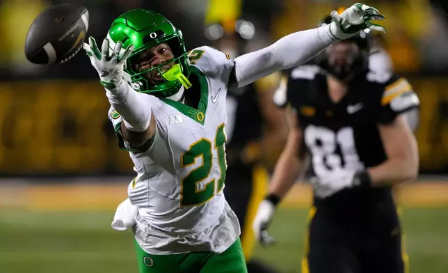 FILE - Oregon defensive back Aaron Flowers (21) reaches for an incomplete pass during the second half of an NCAA college football game against Iowa, Saturday, Nov. 8, 2025, in Iowa City, Iowa. (AP Photo/Charlie Neibergall, File)