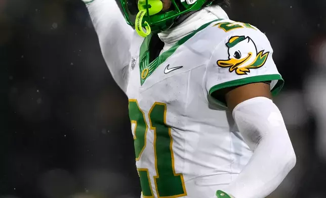 FILE - Oregon defensive back Aaron Flowers (21) gets set for a play during the second half of an NCAA college football game against Iowa, Saturday, Nov. 8, 2025, in Iowa City, Iowa. (AP Photo/Charlie Neibergall, File)