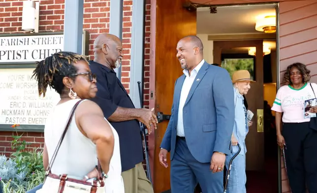 Mississippi Democratic U.S. Senate candidate Scott Colom, center, speaks with an attendee of a voting rights town hall at the historic Farish Street Baptist Church in Jackson, Miss., Saturday, Aug. 1, 2026. (AP Photo/Sarah Warnock)