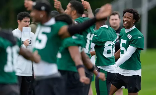New York Jets' Garrett Wilson, right, talks to teammates during practice at the team’s NFL football training camp in Florham Park, N.J., Thursday, July 30, 2026. (AP Photo/Seth Wenig)