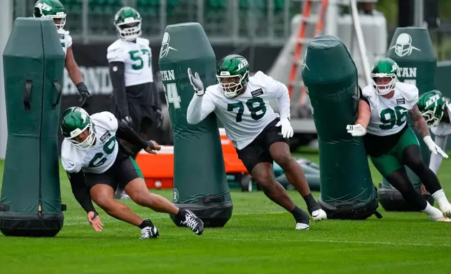 New York Jets' Darrell Jackson Jr (78), center, and others participate during practice at the team’s NFL football training camp in Florham Park, N.J., Thursday, July 30, 2026. (AP Photo/Seth Wenig)