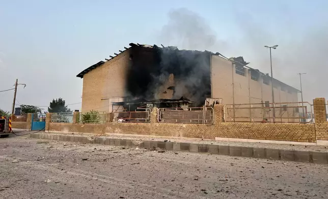 Smoke rises from a building damaged in a strike in Lamerd, southern Iran, Saturday, Feb. 28, 2026. (Alireza Ameri/Tasnim News Agency via AP)
