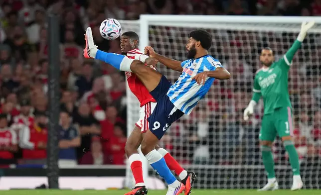 Coventry City's Ellis Simms vies for the ball with Arsenal's Cristhian Mosquera, left, during the English Premier League soccer match between Arsenal and Coventry City in London, Friday, Aug. 21, 2026. (AP Photo/Kirsty Wigglesworth)