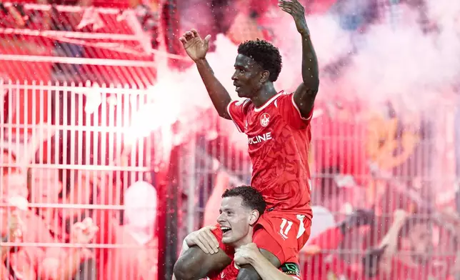 1. FC Kaiserslautern's Ibrahim Kanaté is carried the shoulder's of a teammate after the German Cup soccer match between SV Waldhof Mannheim and 1. FC Kaiserslautern, Friday, Aug. 21, 2026, in Mannheim, Germany. (Uwe Anspach/dpa via AP)