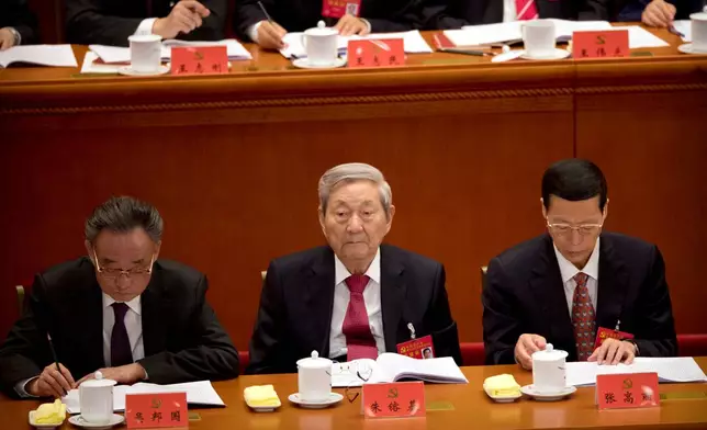 FILE - Former Chinese Premier Zhu Rongji, center, listens to a speech by Chinese President Xi Jinping during the opening session of China's 19th Party Congress at the Great Hall of the People in Beijing, Wednesday, Oct. 18, 2017. (AP Photo/Mark Schiefelbein, File)