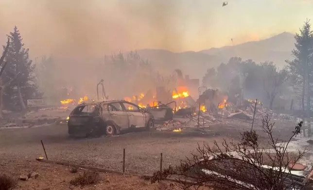 This image taken from video shows a charred neighborhood following wildfires Saturday, Aug. 22, 2026, in Reno, Nevada. (Tim Walton via AP)