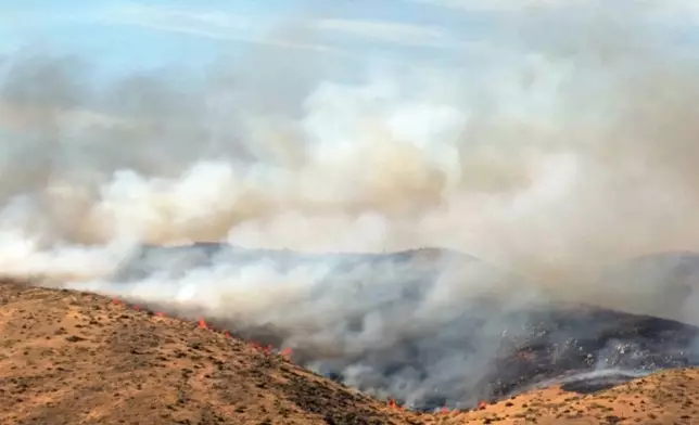 This image taken from video shows active wildfires Saturday, Aug. 22, 2026, in Reno, Nevada. (Tim Walton via AP)