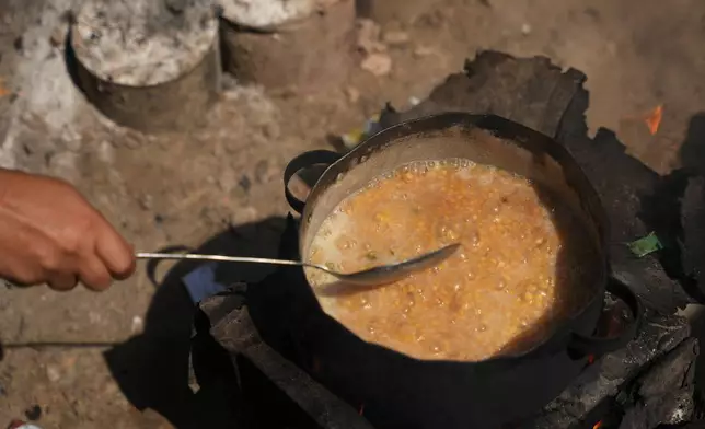 Palestinians use combustible materials collected from a garbage dump as fuel for cooking amid a shortage of cooking gas in Deir al-Balah, central Gaza Strip, Saturday, Aug. 22, 2026. (AP Photo/Abdel Kareem Hana)