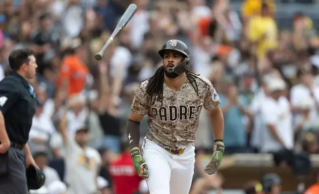 San Diego Padres' Fernando Tatis Jr. tosses his bat after hitting a home run during the fourth inning of a baseball game against the Houston Astros, Sunday, Aug. 9, 2026, in San Diego. (AP Photo/Karl Anderson)