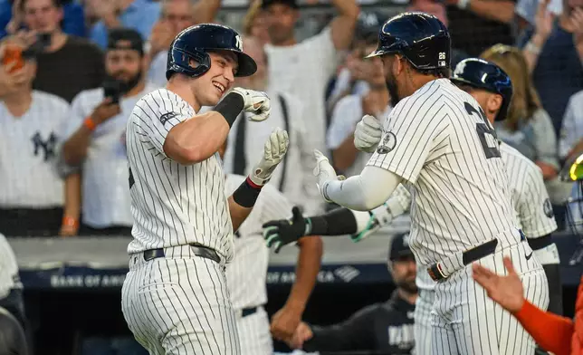 New York Yankees designated hitter Ben Rice, right, celebrates with teammate first baseman Luis García Jr. after hitting a solo home run during the first inning of a baseball game against the Houston Astros Wednesday, Aug. 26, 2026, in New York. (AP Photo/Ryan Murphy)