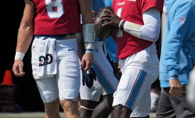 Tennessee Titans quarterback Cam Ward (1) looks to pass as fellow quarterback Will Levis (8) looks on during a joint NFL training camp practice with the San Francisco 49ers Tuesday, Aug. 11, 2026, in Santa Clara, Calif. (AP Photo/Jeff Chiu)