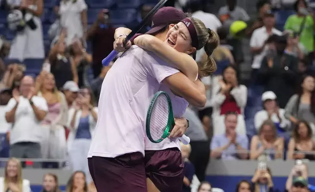 Jakub Mensik, of the Czech Republic, celebrates with Karolina Muchova, right, of the Czech Republic, after they won the mixed doubles final match against Belinda Bencic, of Switzerland, and Flavio Cobolli, of Italy, at the U.S. Open tennis championships Wednesday, Aug. 26, 2026, in New York. (AP Photo/Frank Franklin II)