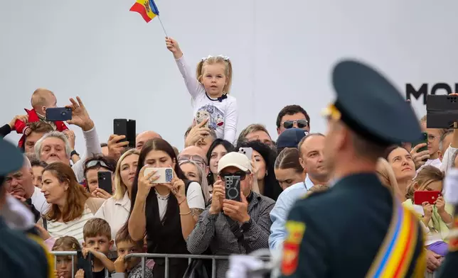 A child waves the Moldovan flag during a parade during celebrations of the 35th Independence Day, in Chisinau, Moldova, Thursday, Aug. 27, 2026. (AP Photo/Aurel Obreja)