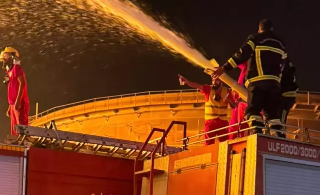 Firefighters work to contain a fire at the Zawiya oil refinery following a drone strike in Zawiya, Libya, Tuesday, Aug. 11, 2026. (Libyan Fire Department via AP)