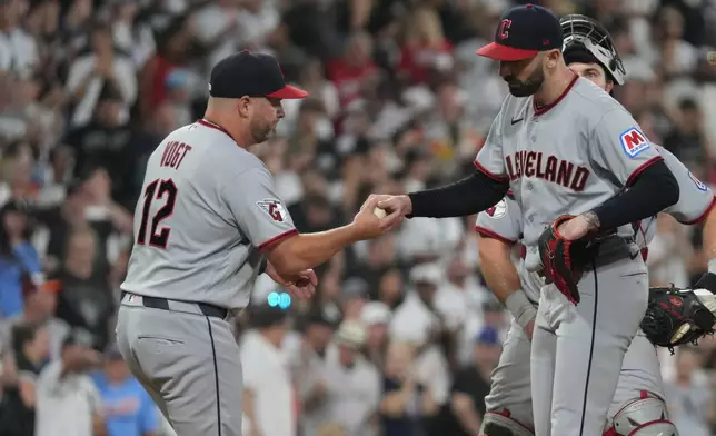 Cleveland Guardians manager Stephen Vogt, left, takes pitcher Colin Holderman, right, out of the game against the Chicago White Sox during the sixth inning of a baseball game Saturday, Aug 8, 2026, in Chicago. (AP Photo/David Banks)