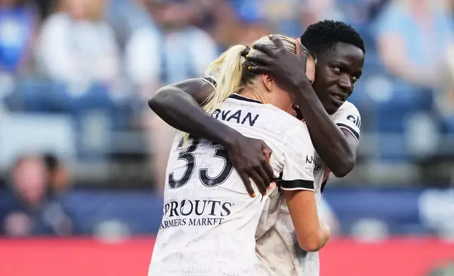 Angel City FC forward Prisca Chilufya, right, hugs teammate Riley Tiernan, left, to celebrate her goal against Seattle Reign FC during the second half of an NWSL soccer match, Sunday, Aug. 9, 2026, in Seattle. (AP Photo/Lindsey Wasson)