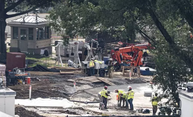 Workers use a jackhammer on the helipad on the South Lawn of the White House, Wednesday, Aug. 5, 2026, in Washington. (AP Photo/Alex Brandon)