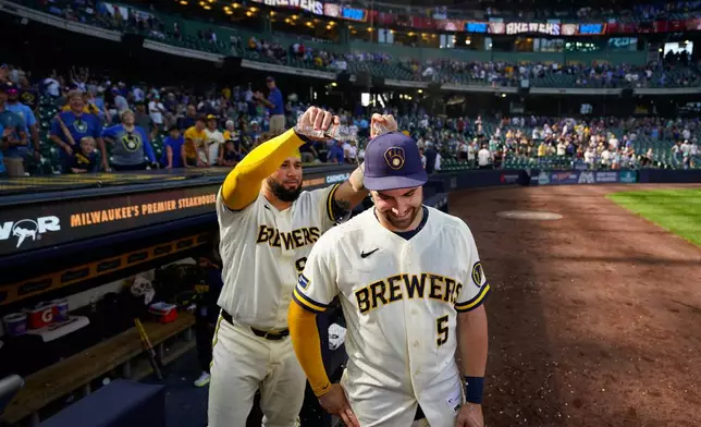 Milwaukee Brewers' Gary Sánchez, left, pours water on Garrett Mitchell (5) after winning a baseball game against the Seattle Mariners Thursday, Aug. 20, 2026, in Milwaukee. (AP Photo/Kayla Wolf)