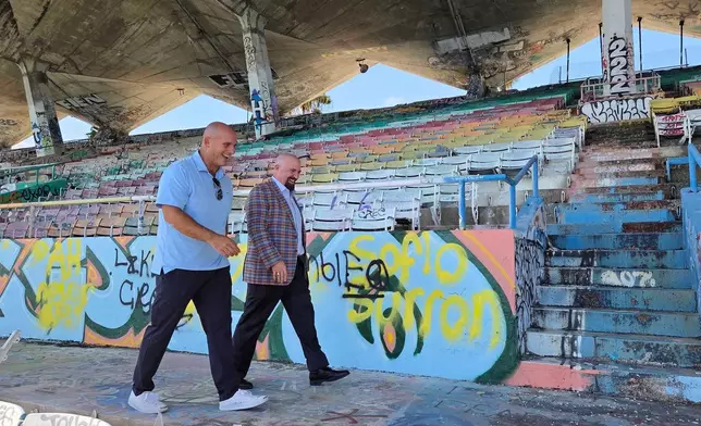 Breakwater Hospitality Group co-founder Emi Guerra, left, and Miami Commissioner Damian Pardo walk through the Miami Marine Stadium on Tuesday, Aug. 11, 2026, in Miami. (AP Photo/David Fischer)