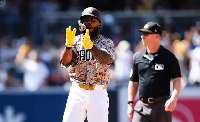 San Diego Padres' Luis Rengifo, left, celebrates after hitting a two-RBI double against Minnesota Twins in the sixth inning of a baseball game Sunday, Aug. 23, 2026, in San Diego. (AP Photo/Derrick Tuskan)