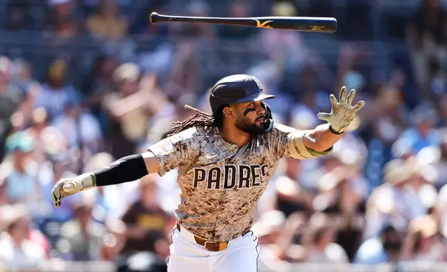 San Diego Padres' Fernando Tatis Jr. tosses his bat after hitting a two-RBI single against the Minnesota Twins in the sixth inning of a baseball game Sunday, Aug. 23, 2026, in San Diego. (AP Photo/Derrick Tuskan)