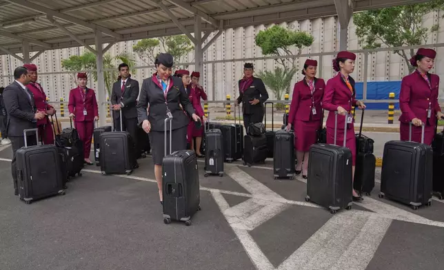 Qatar Airways flight attendants wait to be cleared during a workers strike at Jomo Kenyatta International Airport in Nairobi, Kenya, Monday, Aug. 31, 2026. (AP Photo/Brian Inganga)