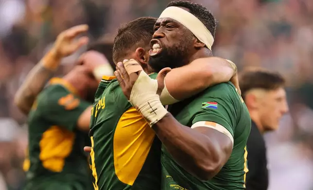 South Africa's captain Siya Kolisi celebrates with his teammate after scoring a try during a second Test rugby match between South Africa and New Zealand, in Cape Town, South Africa, Saturday, Aug. 29, 2026. (AP Photo/Halden Krog)