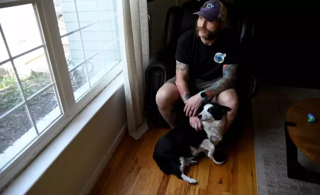 Joe Shearer, who was recently diagnosed with traumatic brain injuries from fighting in Iraq, poses for a portrait in his home in Colorado Springs, Colo., Wednesday, Aug. 5, 2026. (AP Photo/Thomas Peipert)