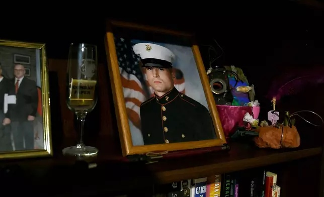 Joe Shearer, who was recently diagnosed with traumatic brain injuries from fighting in Iraq, is seen in his Marine Corps portrait displayed in his home in Colorado Springs, Colo., Wednesday, Aug. 5, 2026. (AP Photo/Thomas Peipert)