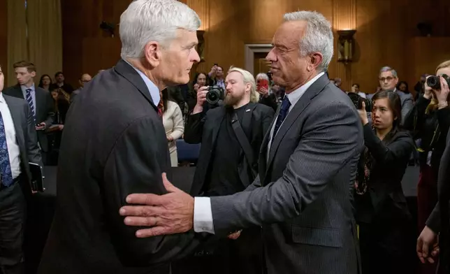 FILE - Robert F. Kennedy, Jr., right, President Donald Trump's nominee to serve as Secretary of Health and Human Services, talks with Committee Chairman Sen. Bill Cassidy, R-La., following his confirmation hearing on Capitol Hill, Jan. 30, 2025, in Washington. (AP Photo/Rod Lamkey, Jr., File)