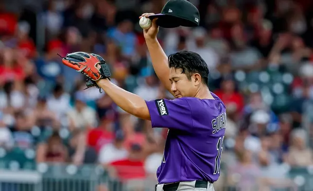 Colorado Rockies pitcher Tomoyuki Sugano reacts between Atlanta Braves batters during the second inning of a baseball game, Friday, Aug. 28, 2026, in Atlanta. (AP Photo/Erik S. Lesser)