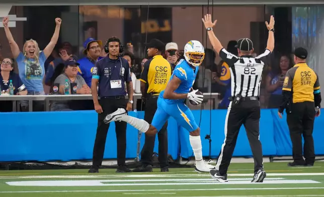 Los Angeles Chargers wide receiver Quentin Johnston, center, celebrates after scoring a touchdown during the first half of an NFL preseason football game against the Los Angeles Rams Thursday, Aug. 27, 2026, in Inglewood, Calif. (AP Photo/Mark J. Terrill)