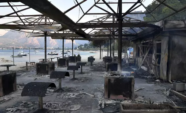 A view of a beach bar in the aftermath of a wildfire on the Adriatic coast near Omis, southern Croatia, Friday, Aug. 14, 2026. (AP Photo/Josko Ponos)