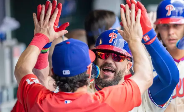 Philadelphia Phillies designated hitter Kyle Schwarber, front right, celebrates in the dugout after hitting a three-run home run during the third inning of a baseball game against the Toronto Blue Jays, Sunday, Aug. 9, 2026, in Philadelphia. (AP Photo/Laurence Kesterson)