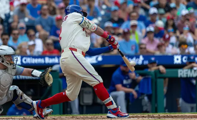 Philadelphia Phillies designated hitter Kyle Schwarber hits a three-run home run during the third inning of a baseball game against the Toronto Blue Jays, Sunday, Aug. 9, 2026, in Philadelphia. (AP Photo/Laurence Kesterson)