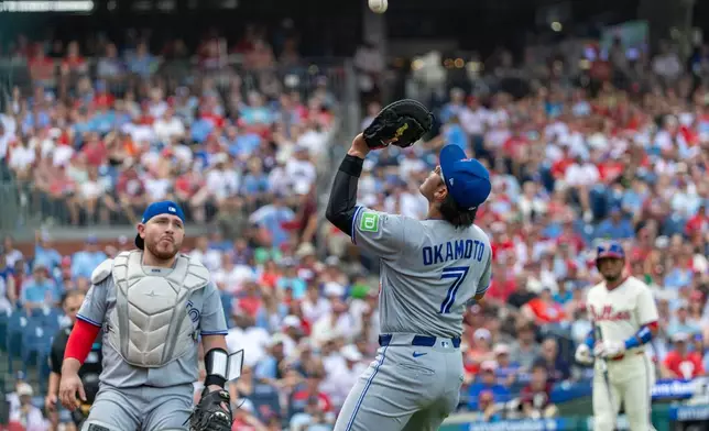Toronto Blue Jays first baseman Kazuma Okamoto (7) catches a fly ball hit by Philadelphia Phillies' Luis Arraez during the second inning of a baseball game, Sunday, Aug. 9, 2026, in Philadelphia. (AP Photo/Laurence Kesterson)