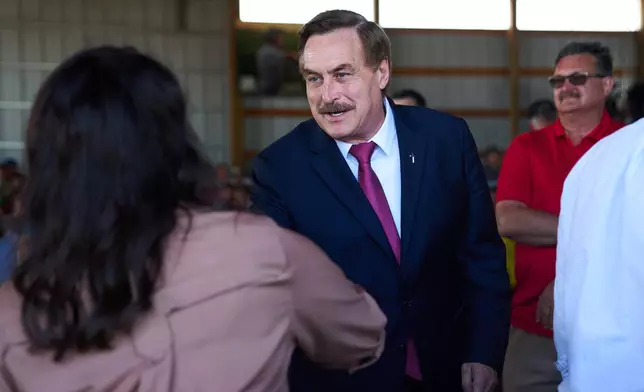 Mike Lindell, gubernatorial candidate, greets Minnesota House Speaker Lisa Demuth, who he will face in the Republican primary, as they arrive to take part in a Minnesota Governor Candidate Forum in Morgan, Minn., Wednesday, Aug. 5, 2026. (AP Photo/Ellen Schmidt)