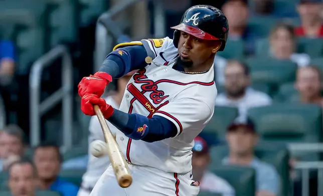 Atlanta Braves' Ozzie Albies (1) hits an RBI sacrifice fly against the Los Angeles Dodgers during the first inning of a baseball game, Tuesday, Aug. 25, 2026, in Atlanta. (AP Photo/Erik S. Lesser)