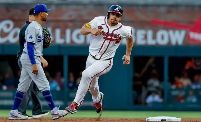 Atlanta Braves designated hitter Drake Baldwin advances from first to third base against the Los Angeles Dodgers during the first inning of a baseball game, Tuesday, August 25, 2026, in Atlanta. (AP Photo/Erik S. Lesser)