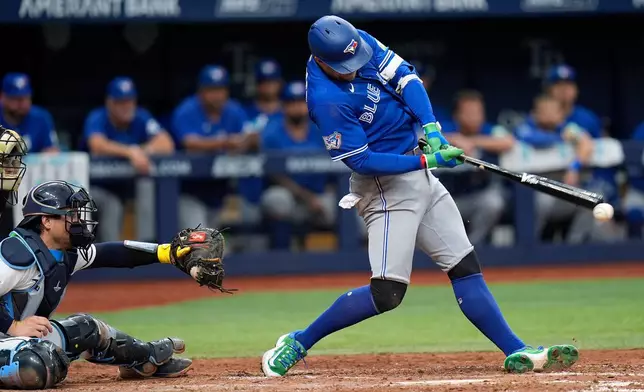 Toronto Blue Jays' George Springer connects for a two-run single off Tampa Bay Rays pitcher Casey Legumina during the seventh inning of a baseball game Thursday, Aug. 20, 2026, in St. Petersburg, Fla. (AP Photo/Chris O'Meara)