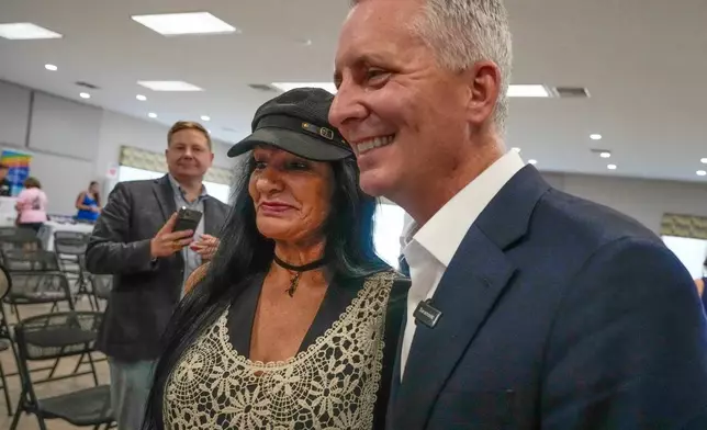 Florida Democratic gubernatorial candidate David Jolly, right, poses for a photo with supporter Cyn Doyle, after a town hall meeting, Saturday, Aug. 8, 2026, in Leesburg, Fla. (AP Photo/John Raoux)