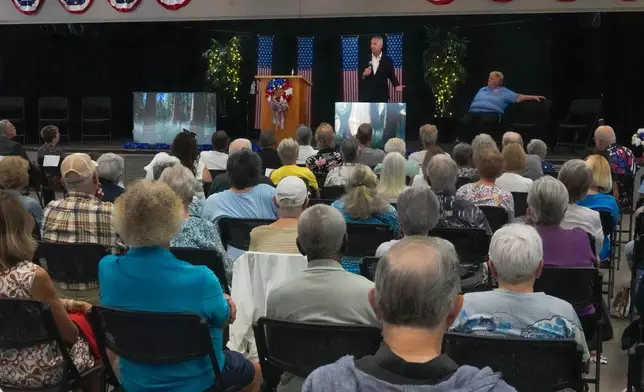 Florida Democratic gubernatorial candidate David Jolly, back center, speaks to voters during a town hall meeting, Saturday, Aug. 8, 2026, in Leesburg, Fla. (AP Photo/John Raoux)