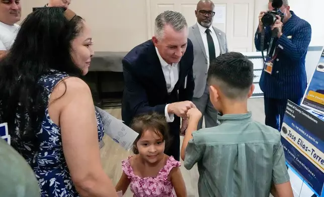 Florida Democratic gubernatorial candidate David Jolly, center, greets supporters after a town hall meeting, Saturday, Aug. 8, 2026, in Leesburg, Fla. (AP Photo/John Raoux)